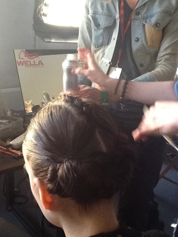 Next the model's hair is fixed in place with Wella Stay Essential Hairspray for the Jeremy Scott hair look. #NYFW