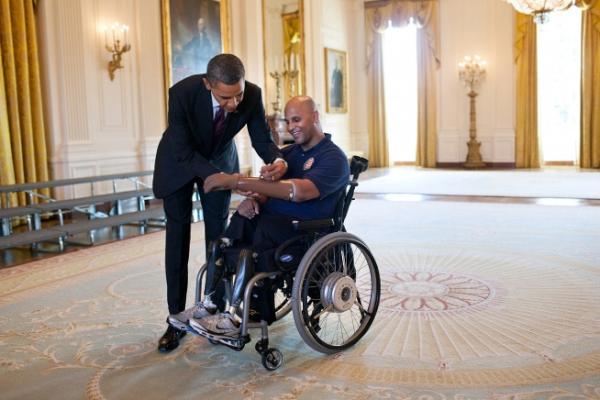 Relive44's tweet photo. Photo of the Day: President Obama greets wounded warriors #AtTheWH & signs prosthetic arm of @USMC Sgt Carlos Evans: https://t.co/bdI597E5oj