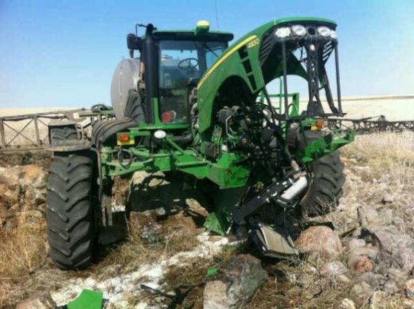 Guy hits rock pile with sprayer John Deere