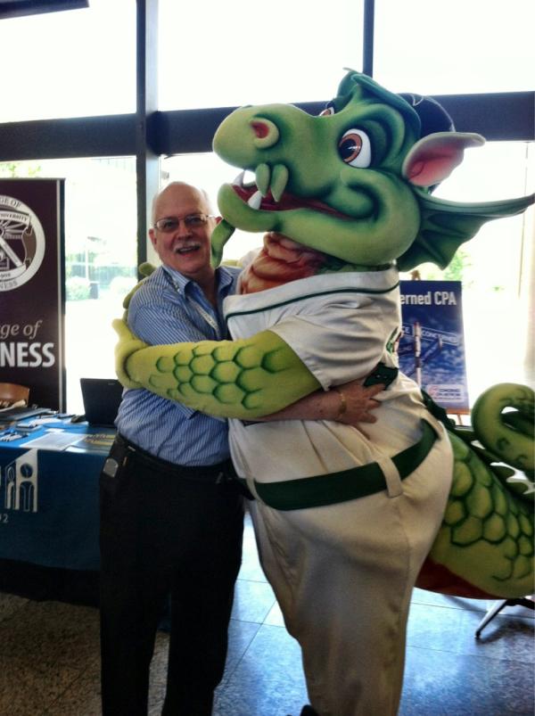 OSCPA's tweet photo. Greg Schade, Concerned CPA Network Task Force Chair, gets a hug from Dayton Dragons mascot, Heater. #OASDA http://t.co/2xMMR4pQ