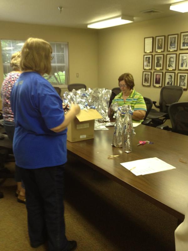Our sweet volunteers hard at work on wrapping 100 bottles of wine for the wine pull. #ESTackyProm