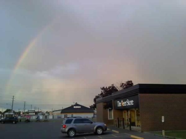 speters300's tweet photo. was actually a double rainbow over the beer store... #undertherainbow #nopotofgold #wishihadmyrealcamera #shittycellpic http://t.co/bfCllX5b