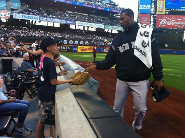 MLBONFOX's tweet photo. As he walked into the dugout, #Yankees' Ivan Nova gave a young Yankees a fan a treat. #NiceGuyMove #SubwaySeries http://t.co/ETt4nv7i