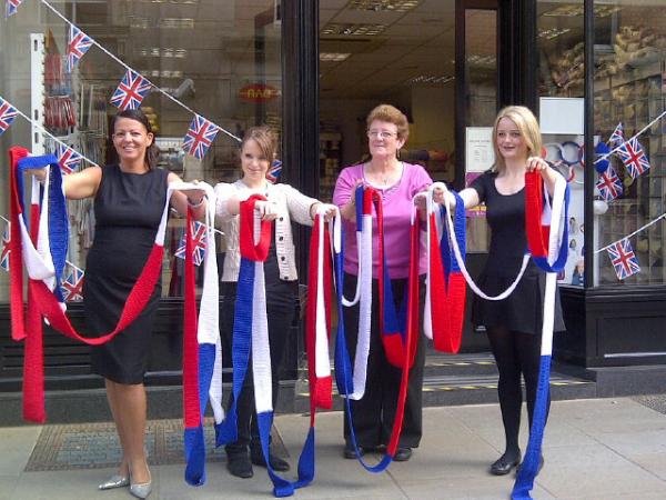 bakerToCoder's tweet photo. Ladies from The Strand with an enormous knitted #olympics banner from @strandwools2 - on the right our own @love_cakes http://t.co/OeMVLImr