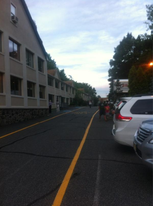 Benrush11's tweet image. Hard to see, but this is my hotel evacuated to the parking lot because the fire alarms went off. #notsensible