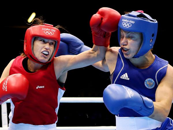 SkySports's tweet photo. Pic: Katie Taylor lands a punch on her way to gold in the Women's Light Boxing final #London2012 http://t.co/ZR8fHpbp