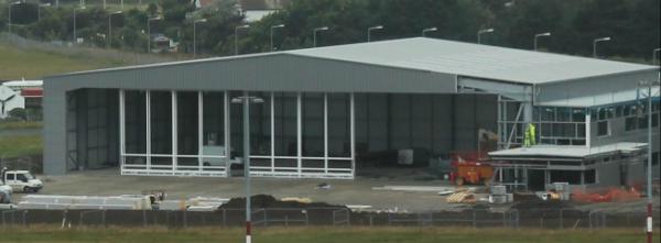 IOMCharter's tweet photo. The Doors are going on @privatejetco Brand New Business Aviation Facility. Looking Good. http://t.co/vMoq8JWH