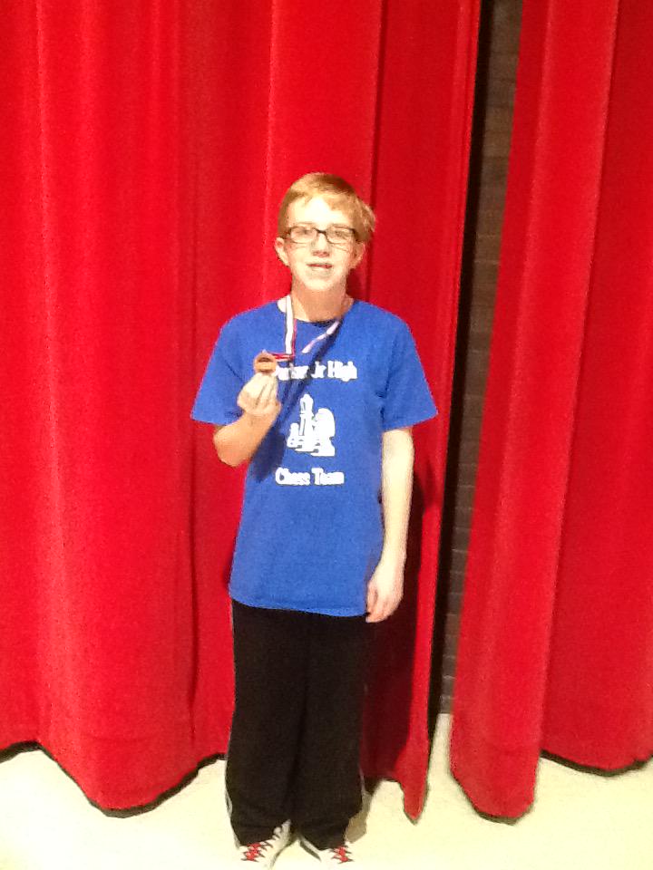 Perry Hoag shows his bronze medal at the IESA State Championship.