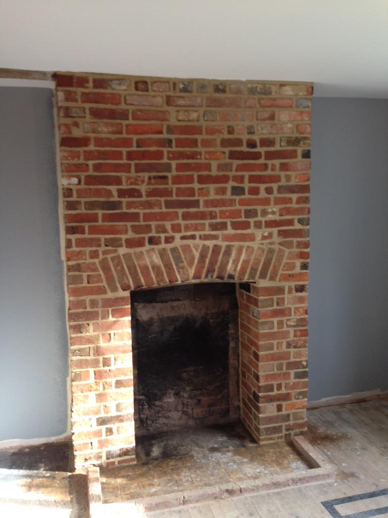 Chimney restoration project  plaster removed and old brickwork exposed