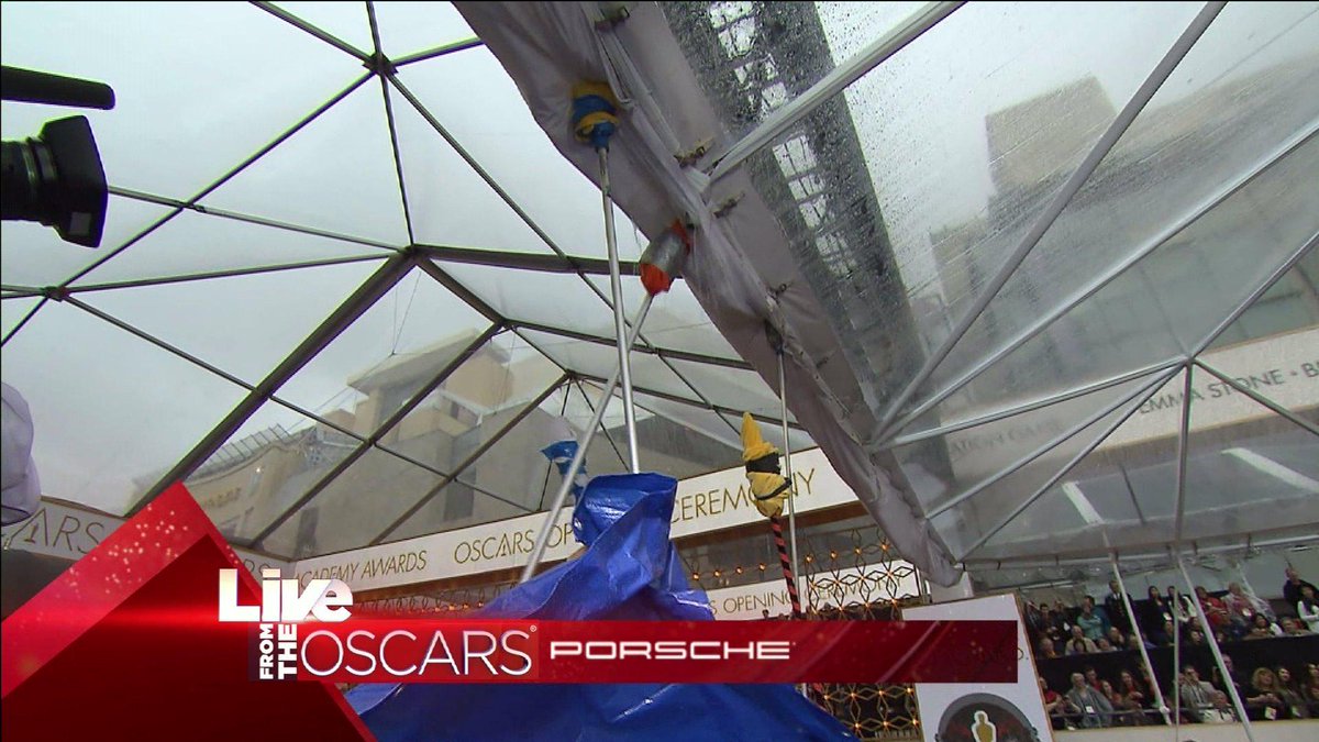 Rain on the #Oscars red carpet! @MichaelKeaton, @jessicaktla and @SamOnTV trying to stay dry! ktlane.ws/1D7aHUv