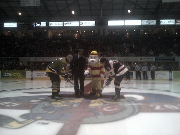 DEPUTYHOFFMANN's tweet photo. Deputy Weber &amp; @Sparky_Fire_Dog dropping the puck @OHLBarrieColts. Raising awareness of #COawarenessweek @BarriePFFA http://t.co/NjkzMPHPIC