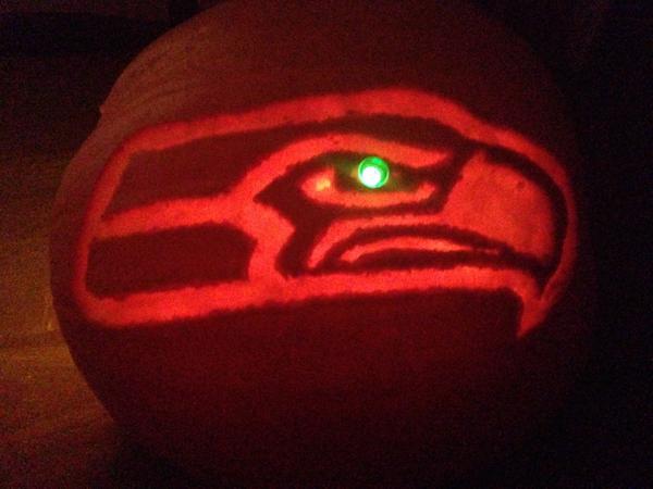 CoachCallero's tweet photo. Pumpkin carving after a @Seahawks victory includes the neon green eye #HawkOLantern http://t.co/vKLxiBsEqi
