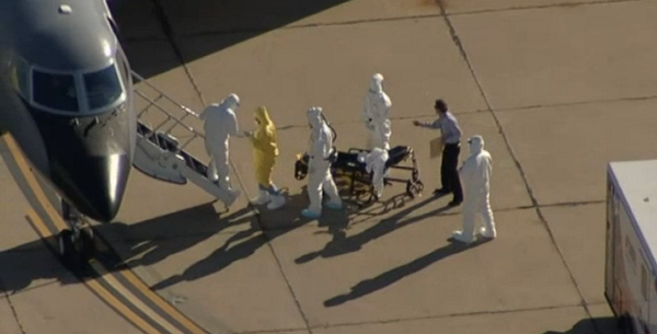 NBCNews's tweet photo. Who is the mystery man wearing plain clothes during an #Ebola patient's transfer? http://t.co/kuBPGq3k62 via @NBCDFW http://t.co/NrdXoo1RkX