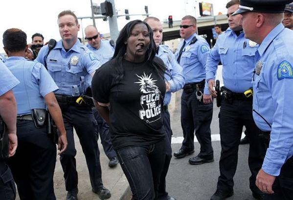 Watch video: Black Mike Brown female protester cusses out spits at white person outsite St. Louis Dome