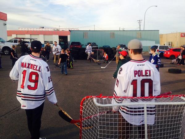 DeanWilyums's tweet photo. @Rebelshockey at #KalTire hanging with their fans. #backtotheirroots #car! #getaburger http://t.co/5cq1zxFpat