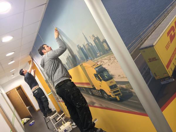 Richardsigns's tweet photo. The team hard at work fitting wallpaper at DHL Langley Mill. http://t.co/23dTqPeFSj