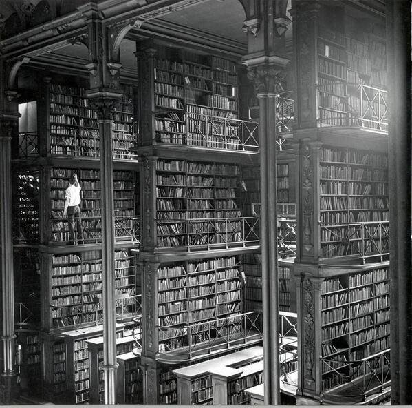 VeryOldPics's tweet photo. A man browsing for books in Cincinnati's cavernous old main library. The library was demolished in 1955. http://t.co/OhMCmJo5hx