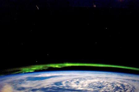 The aurora borealis (northern light) is visible from the Earth's orbit.