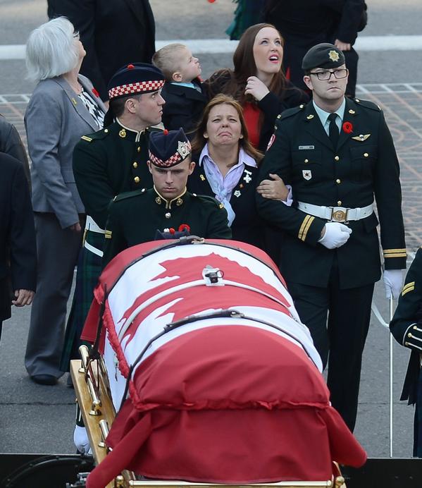 Kathy Cirillo looks up as Mitchell bomber does fly-past  during Cpl. Nathan Cirillo's funeral in #HamOnt Tuesday