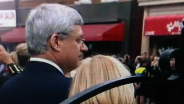 spaikin's tweet image. Stephen and Laureen Harper among the thousands lining the streets of Hamilton to watch Cirillo’s procession.
