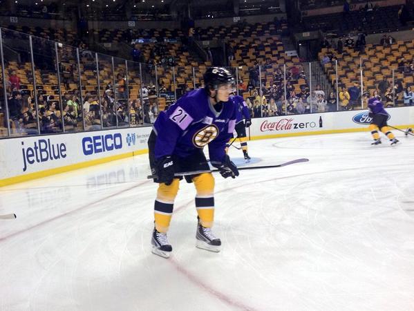 NHLBruins wearing purple warmup jerseys 