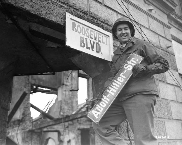 VeryOldPics's tweet photo. An American soldier replaces "Adolf-Hitler-Str." sign with a "Roosevelt Blvd" one in Berlin, Germany, 1945. http://t.co/Kd8GCvJKA5