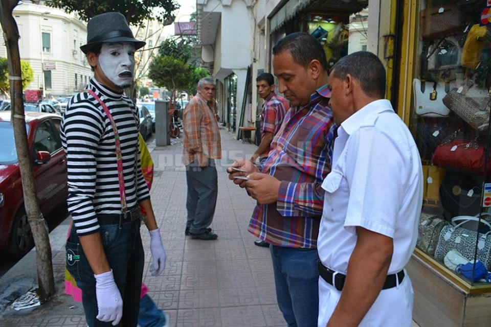This is a picture of cops stopping a mime and asking him for his papers.