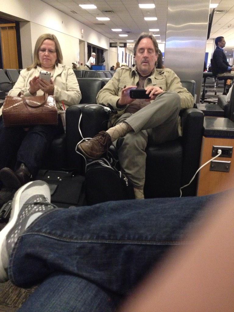 jakemcguire31's tweet photo. Theses two rock their own extension cord at the airport. She's playing candy crush and he is on tinder. #hemightbe http://t.co/5viOd27WlS