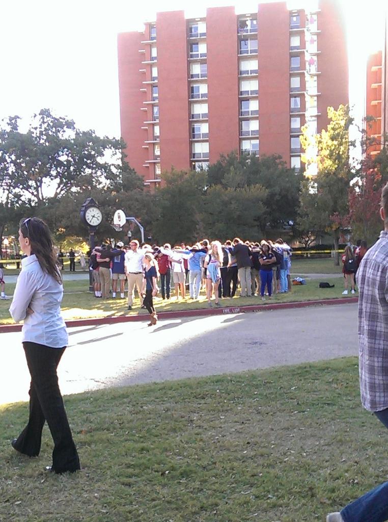 ari_pickard's tweet photo. It looks like students are praying in a circle outside of Adams Hall while a student sits up on a ledge. http://t.co/DGV0KDR6Am