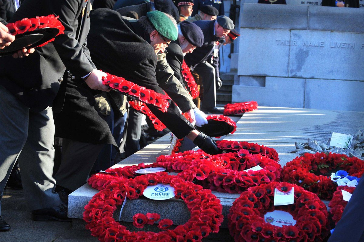 Veterans lay wreaths at the Cenotaph in Glasgow's George Square. Image ...