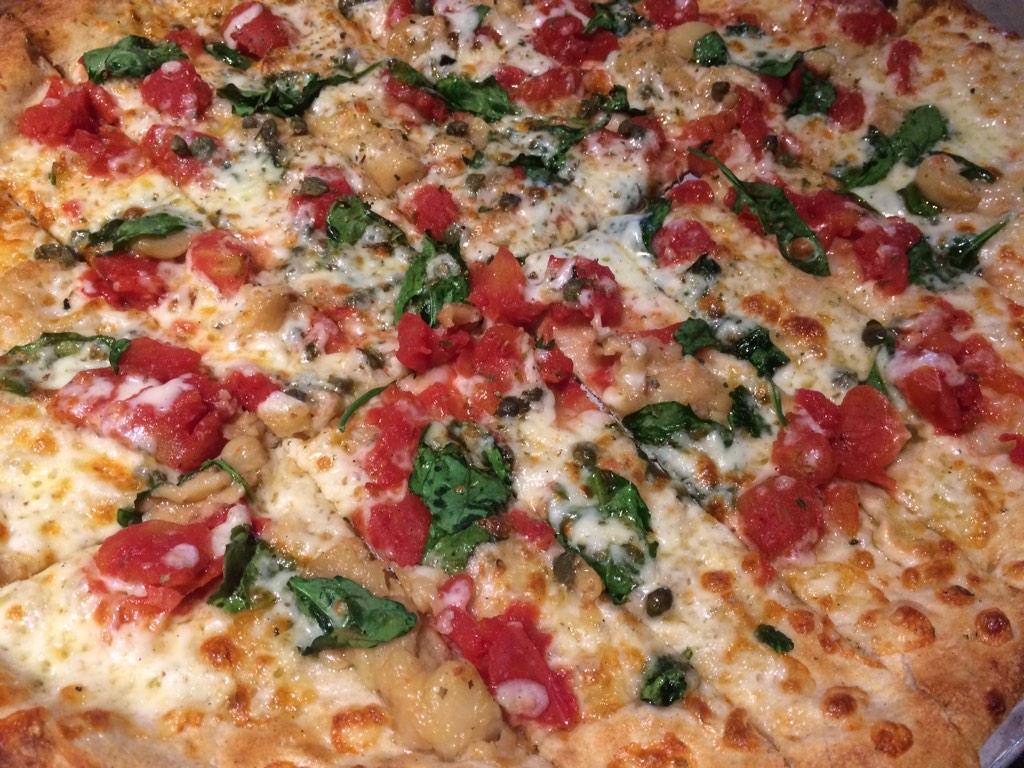The veggie has organic oven roasted garlic w/organic diced tomatoes, capers, organic baby spinach, mozz, parm, herbs