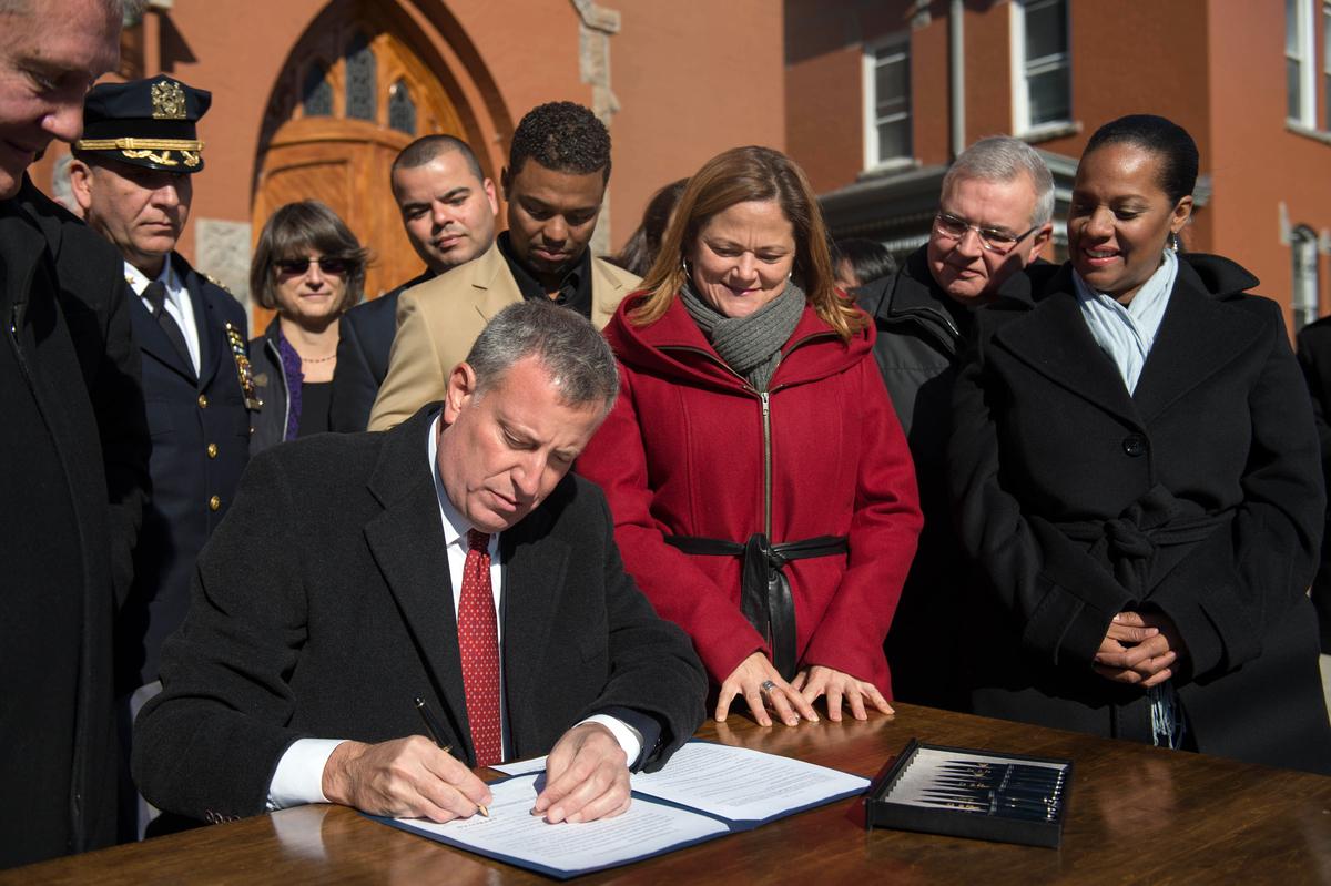 NYCMayor's tweet photo. Proud to sign legislation that will keep families together and make our city stronger. http://t.co/sV5wxd9GL9 http://t.co/s7rDNScT3d