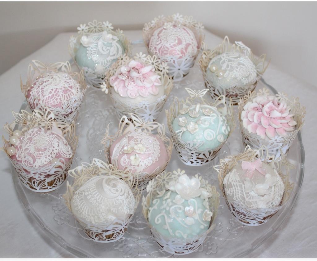 Cupcakes decorated with lace, beads, and sugar flowers