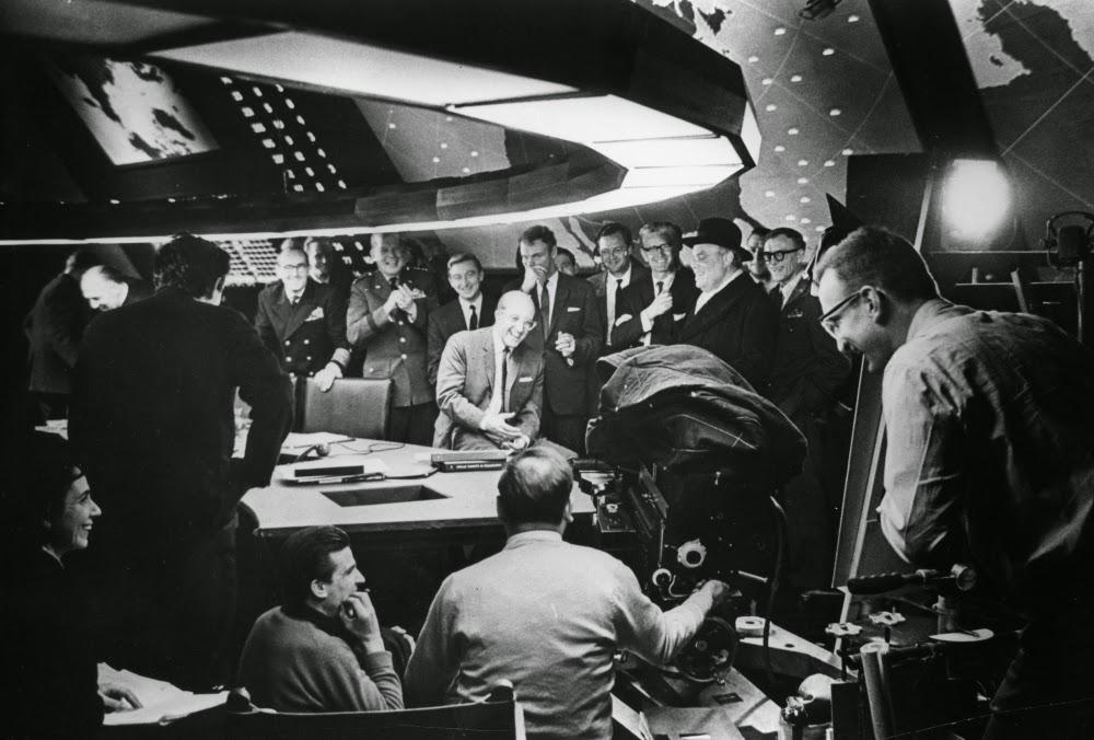 NotableHistory's tweet photo. Peter Sellers shares a joke with cast in Ken Adam’s famous war room set for the Kubrick film Dr. Strangelove, 1964. http://t.co/nkpM3VncUJ