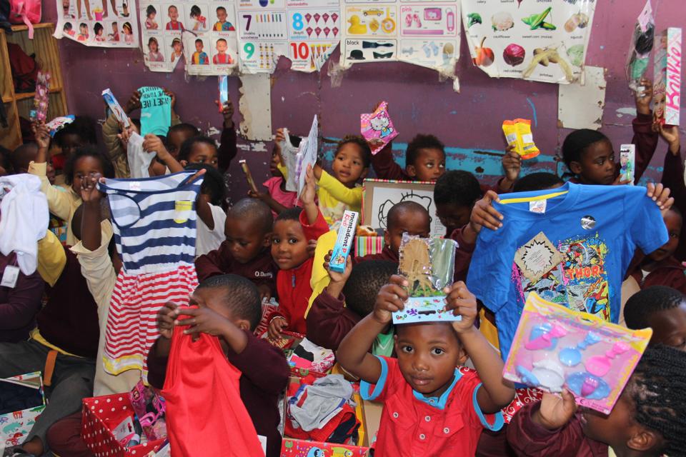 SantaShoebox's tweet photo. "I asked the kids to show me their favourite thing in their box..." There's a lot of toothpaste waving. #SSB2014 http://t.co/y8WTFDcbmB