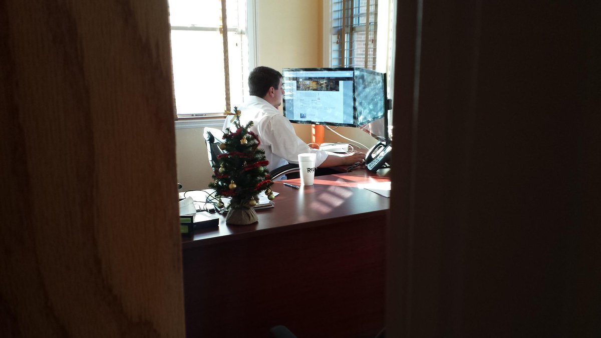 WearInteractive's tweet photo. We snuck a Christmas tree on Mike's desk. http://t.co/yutjOJnHt3