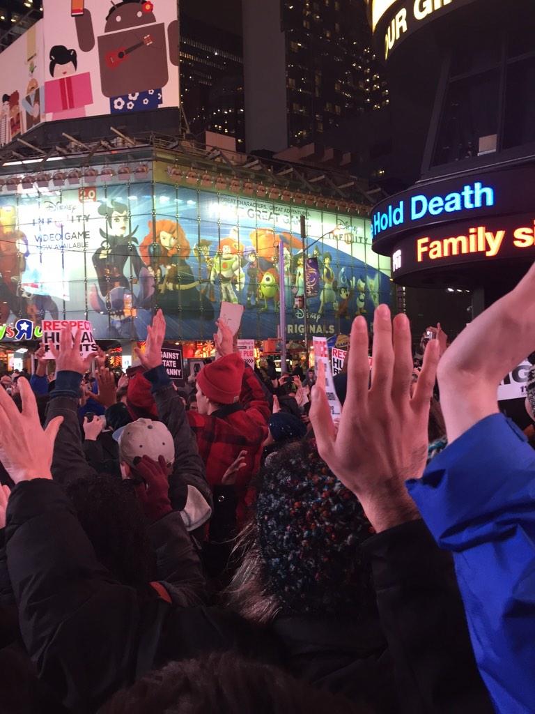 Complex's tweet photo. Moment of silence in Times Square. #EricGarner http://t.co/FavjgqY1tQ