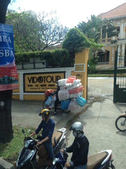 MHinkelman's tweet photo. Downright amazing what you can fit on back of a motorbike. A common scene in Saigon. #bikesofburden http://t.co/VzFMrBirSx