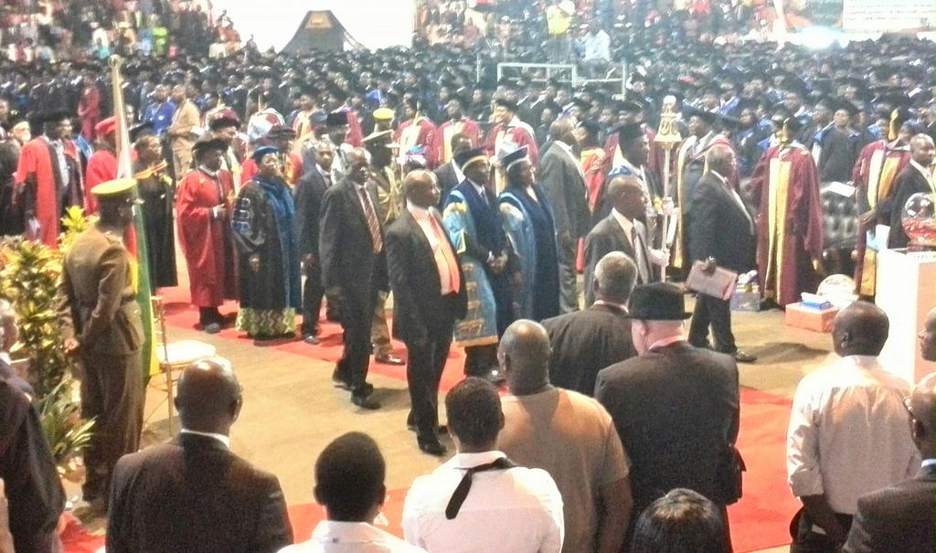 cemambo's tweet photo. End of #ZOUgraduation ceremony. Pres Mugabe (in blue gown) leads academic procession out http://t.co/TXlESZjQWK