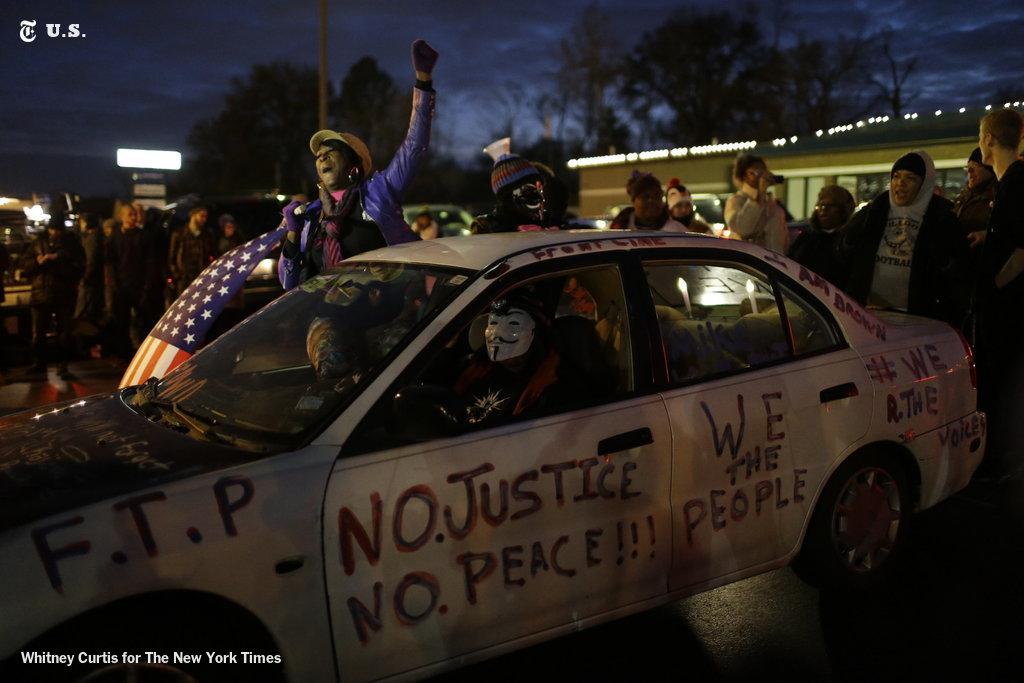 nytimes's tweet photo. Live updates from Ferguson on the grand jury decision in the Michael Brown shooting http://t.co/xKhizd6VHX http://t.co/hS2173wBf0