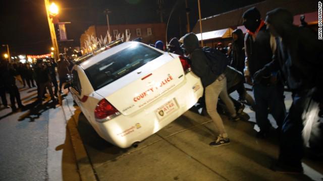 Police fire tear gas at protesters trying to overturn a patrol car. #FergusonDecision cnn.it/1uSgkn9