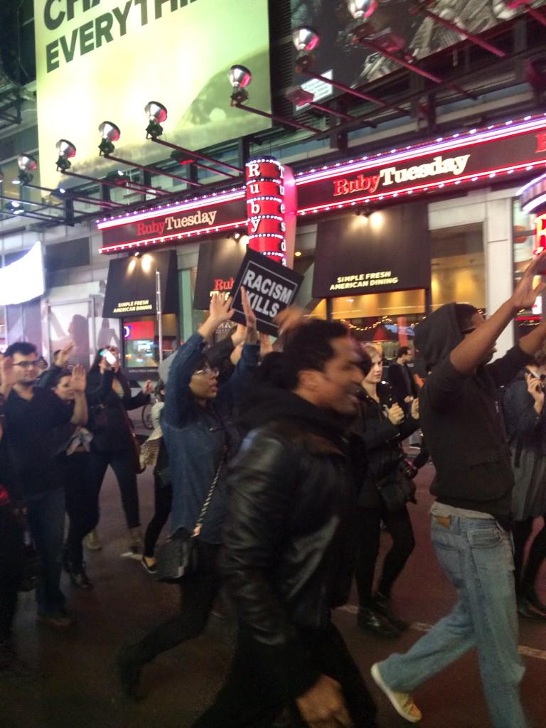 OkayAfrica's tweet photo. .@QtipTheAbstract is leading this NYC crowd in "hands up don't shoot" chant. #TimesSquare #Ferguson http://t.co/PixKKvwJsD