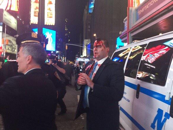 YourAnonCentral's tweet photo. #US: Fake blood thrown on at NYC police commissioner in Times Sq last night #Ferguson #MikeBrown #FergusonDecision http://t.co/ElxJzxjRv2