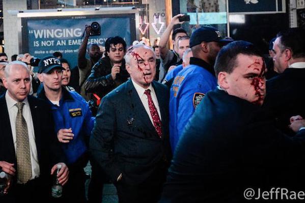 YourAnonCentral's tweet photo. #US: Fake blood thrown on at NYC police commissioner in Times Sq last night #Ferguson #MikeBrown #FergusonDecision http://t.co/ElxJzxjRv2
