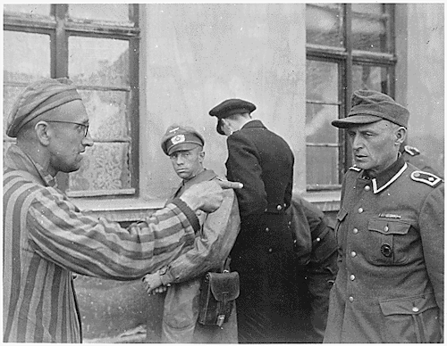 HistoryInPics's tweet photo. Slave laborer liberated by Armored Division, points out former Nazi guard who brutally beat prisoners Germany, 1945 http://t.co/RRXJ60KEgh