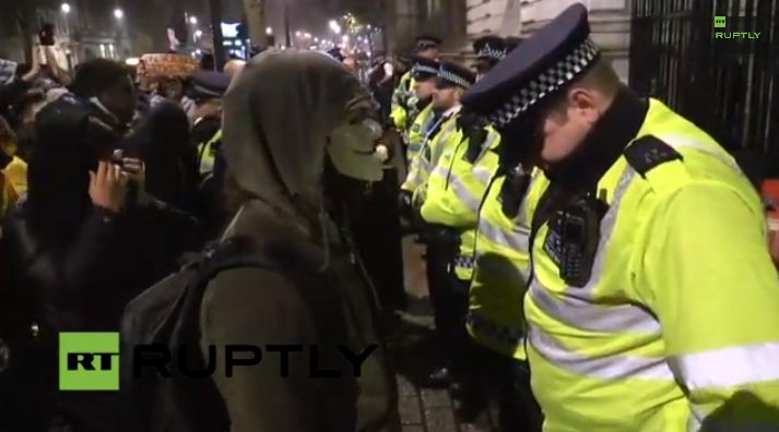hash_said's tweet photo. Guy Fawkes stares down a London police officer. Heh. #LondonToFerguson http://t.co/iPQeFkKsmI