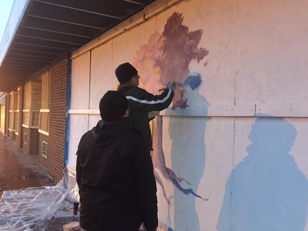 Rebelutionary_Z's tweet photo. Residents beautifying the boarded up "#Ferguson Optical" building on S Florrisant. http://t.co/hQXLIgCqDm