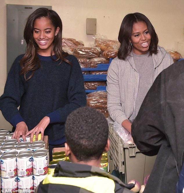 Malia Obama is a Michelle mini-me as she helps at a homeless shelter over the Thanksgiving holiday in Washington D.C