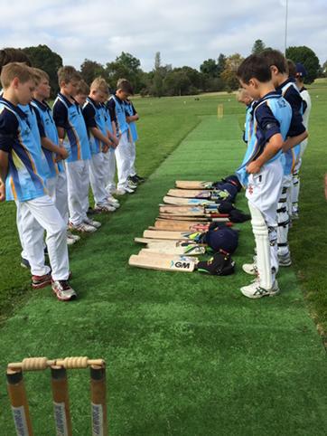 The Brighton u12 boys stop to remember Phil Hughes before play this morning.