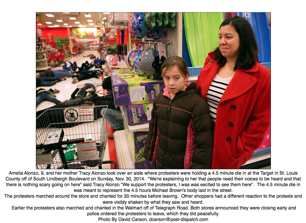 PDPJ's tweet photo. A different scene from tonight's #Ferguson protest @Target in S #STL Co., a teachable moment from mother to daughter http://t.co/g4wQPER4bW